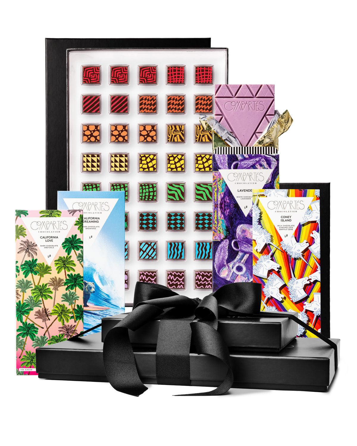 Compartes gourmet chocolate gift tower, black boxes with a satin bow, patterned truffles and illustrated bars