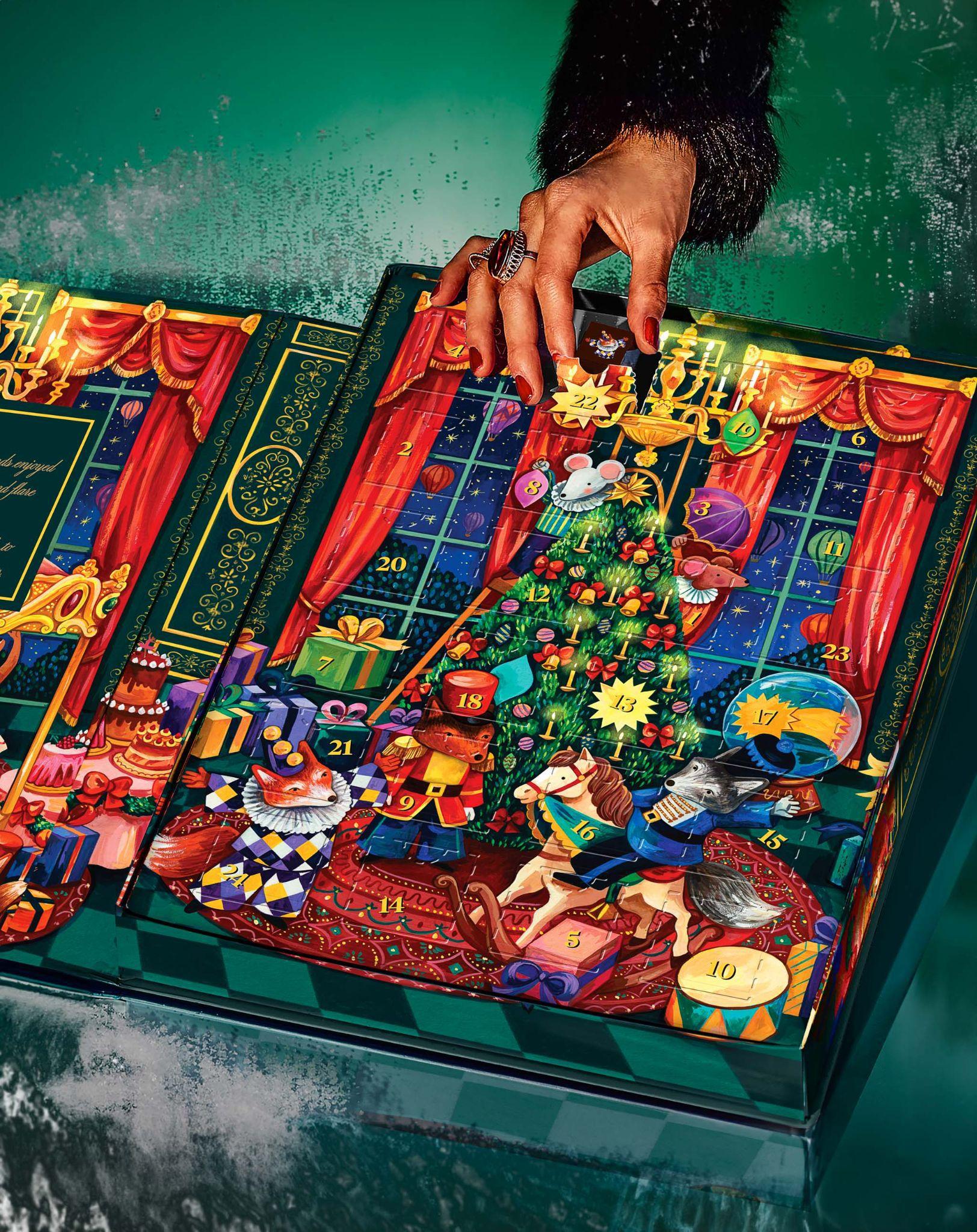 Person taking chocolate truffle from advent calendar