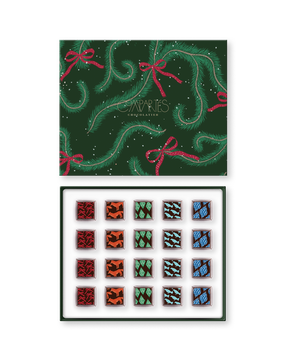 Compartes gourmet Christmas chocolate truffles in a green pine print gift box, squares with deer and pine motifs