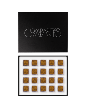 Compartes luxury champagne chocolate truffles in a black gift box, squares in deep gold swirl patterns