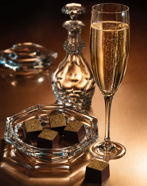 Champagne Chocolate Truffles by Compartes Beverly Hills. Handmade dark chocolates with champagne in a premium luxury gift box, shown on a platter.