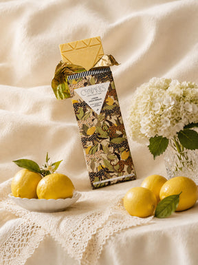 Compartes Fancy Chocolate Bar series of Lemon Shortbread with White Chocolate and Lemon on a gorgeous white tablescape with flowers and lemons.