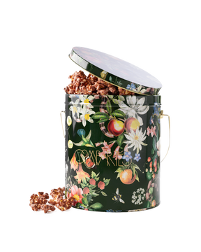 Compartes best chocolate covered popcorn gift, milk chocolate popcorn in a deep green botanical tin