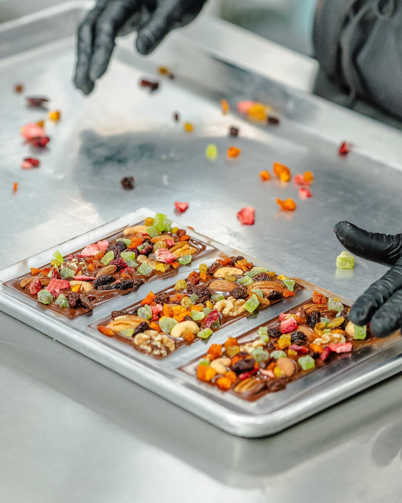 Chocolate bar molds with chocolate, fruit, and nuts	