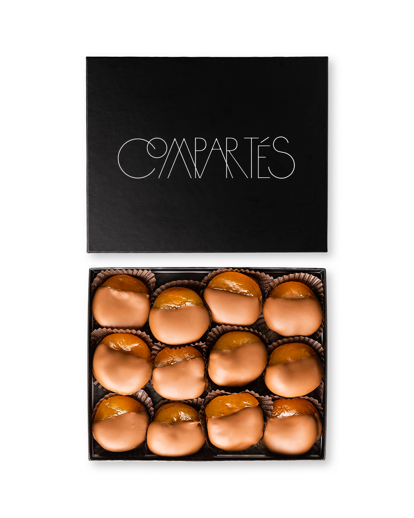 Compartes gourmet milk chocolate dipped apricots, smooth milk chocolate pieces in a black gift box