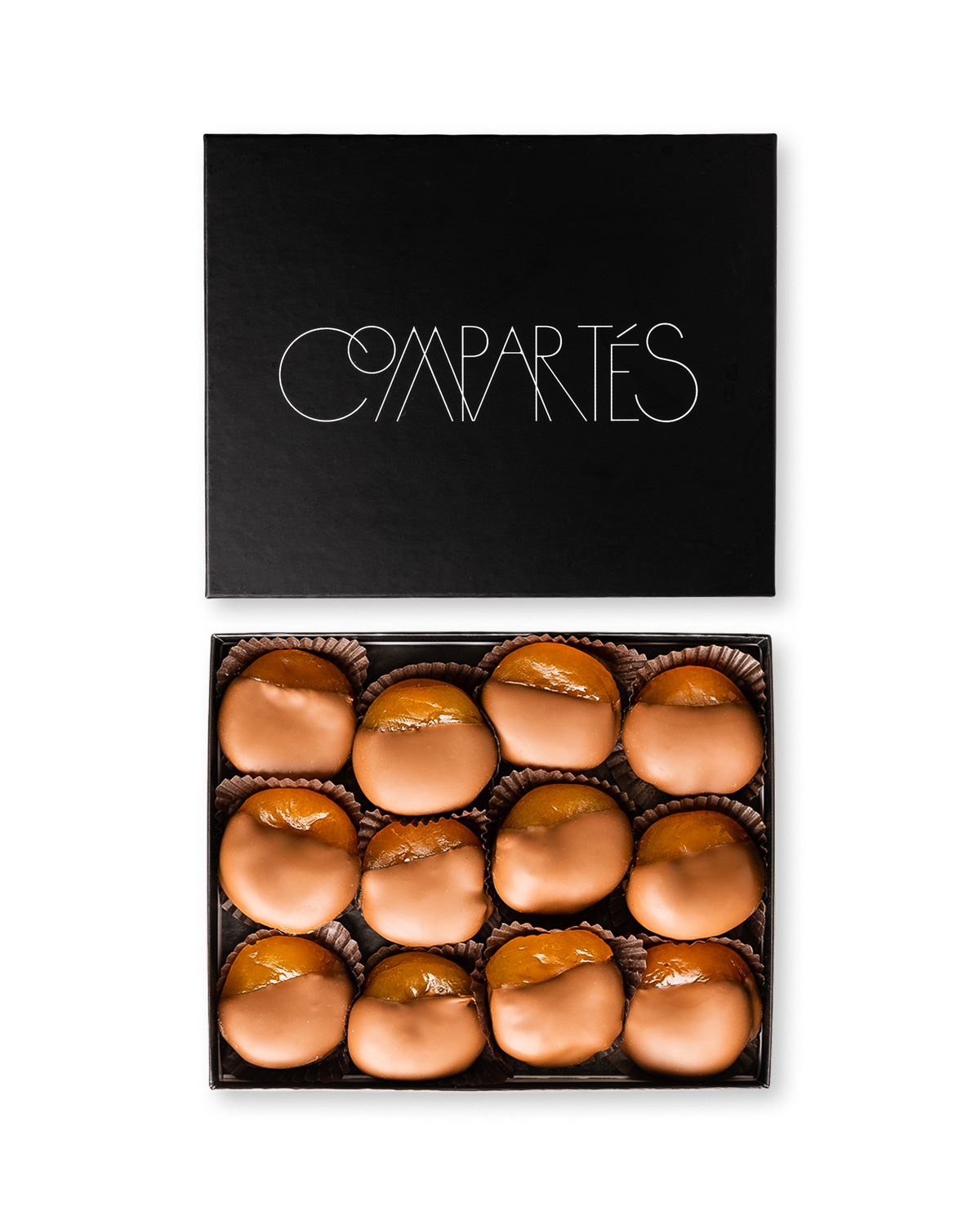 Compartes gourmet milk chocolate dipped apricots, smooth milk chocolate pieces in a black gift box