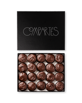 Compartes gourmet peanut butter cups in dark chocolate, swirled tops in a black gift box