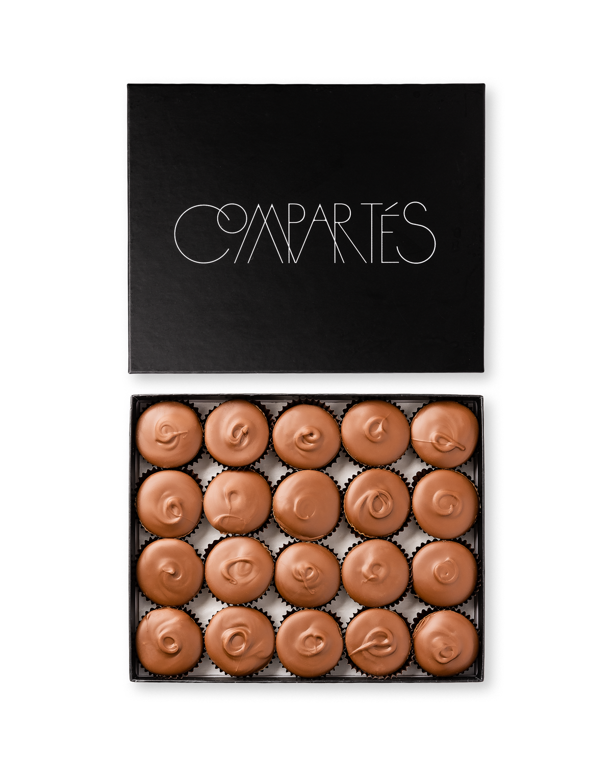 Compartes gourmet peanut butter cups in milk chocolate, swirled tops in a black gift box