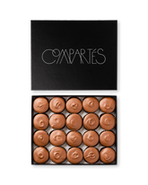 Compartes gourmet peanut butter cups in milk chocolate, swirled tops in a black gift box