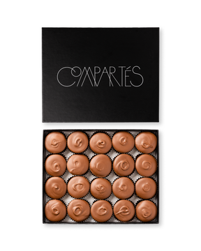 Compartes gourmet peanut butter cups in milk chocolate, swirled tops in a black gift box