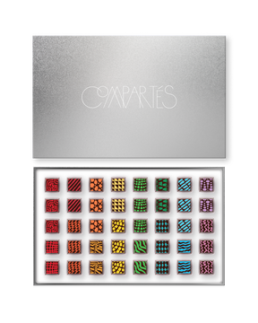 Compartes luxury signature chocolate truffles in a silver gift box, squares in rich red, green and blue patterns