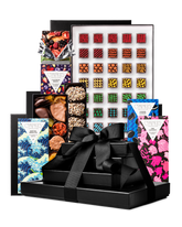 Compartes best chocolate gift tower, stacked black boxes with a satin bow, patterned truffles and bars