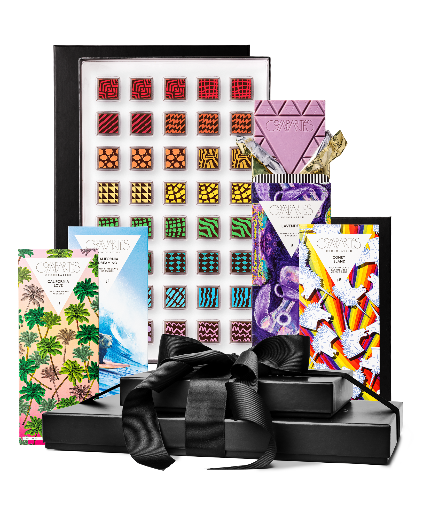 Compartes gourmet chocolate gift tower, black boxes with a satin bow, patterned truffles and illustrated bars