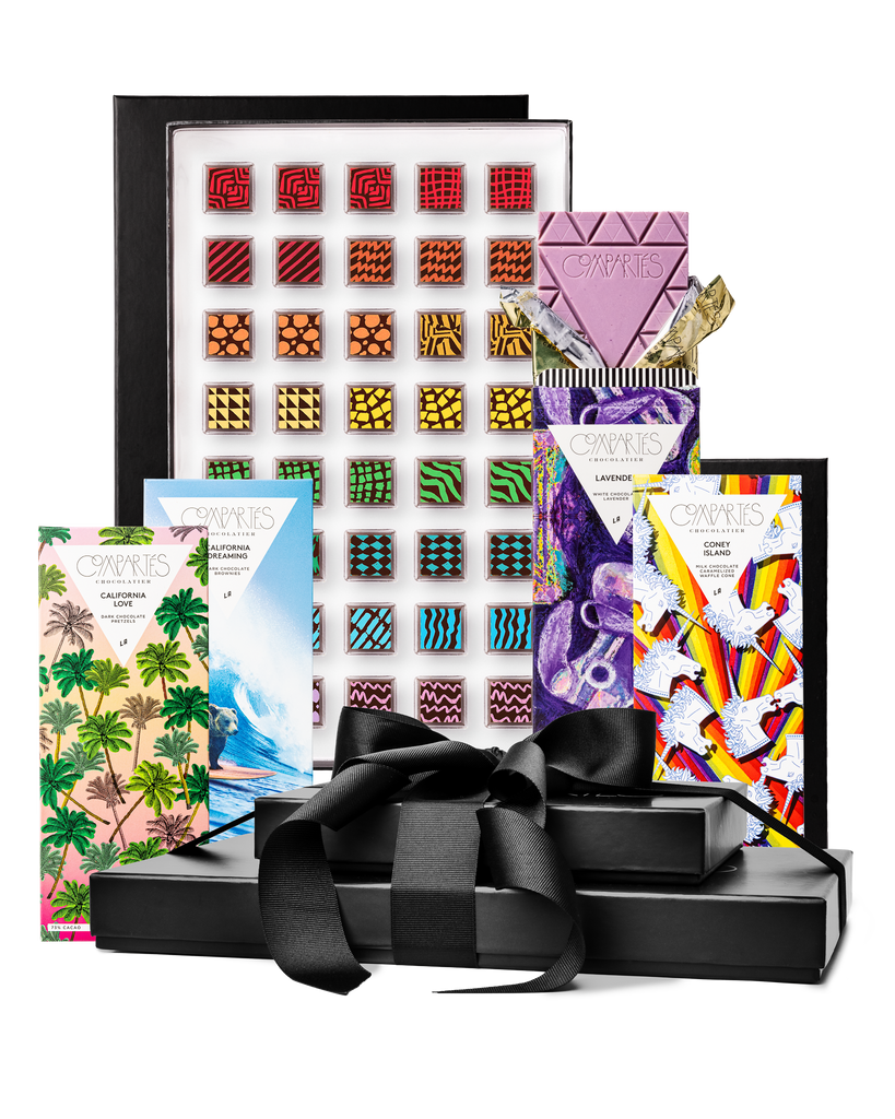 Compartes gourmet chocolate gift tower, black boxes with a satin bow, patterned truffles and illustrated bars