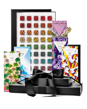 Compartes gourmet chocolate gift tower, black boxes with a satin bow, patterned truffles and illustrated bars