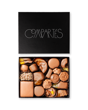 Compartes world famous gourmet chocolates, milk chocolate pieces in a black gift box